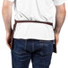 A man wearing a brown Uncommon Chef waist apron.