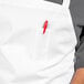 A white Uncommon Chef bib apron with red pockets.