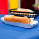 A hot dog in a Heavy Weight white paper fluted tray.