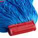 A close up of a blue Carlisle microfiber wet mop head with a red headband.