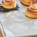 A tray of cinnamon rolls wrapped in Choice non-stick aluminum foil.