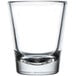 A clear Libbey shot glass with a white background.