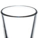 A Libbey shot glass filled with clear liquid.