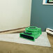 A green B-Air Ventlo-25 low profile air mover on a rug in a room.