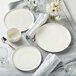 A white table set with Luzerne Hamptons white porcelain coupe plates.