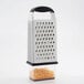 An OXO stainless steel box grater with cheese on it.