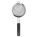 An OXO stainless steel fine mesh strainer with a black handle.