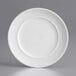 An Acopa Liana white porcelain plate with embossed lines on the rim.