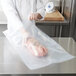 A person holding a piece of meat in an ARY VacMaster plastic bag.