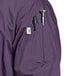 A close-up of a purple Uncommon Chef 3/4 length sleeve chef coat pocket.