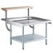 A Regency stainless steel equipment stand with a wooden top and a shelf underneath.