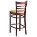 A Lancaster Table & Seating mahogany wood bar stool with light brown vinyl seat and back.