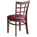 A Lancaster Table & Seating wooden chair with a burgundy vinyl cushion.
