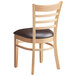 A Lancaster Table & Seating wooden chair with a dark brown vinyl seat.