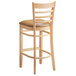 A Lancaster Table & Seating wooden bar stool with a light brown cushioned seat.