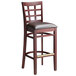 A Lancaster Table & Seating mahogany wood bar stool with a dark brown vinyl seat.