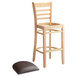 A Lancaster Table & Seating wooden ladder back bar stool with a dark brown cushion.
