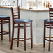 Lancaster Table & Seating Mahogany Ladder Back Bar Height Chair with Navy Padded Seat Main Thumbnail 1