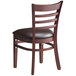 A Lancaster Table & Seating mahogany wood ladder back chair with a dark brown vinyl seat.