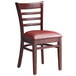 A Lancaster Table & Seating wooden ladder back chair with burgundy vinyl seat