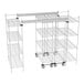 A Metro chrome top-track shelving unit with wheels and shelves.