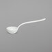 A white ladle with a white bowl on a gray surface.