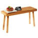 A table with a Cal-Mil Madera rustic pine wood riser holding a plate of fruit.
