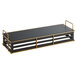 A black rectangular metal riser with gold trim on two shelves.
