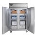 A Continental Refrigerator silver reach-in freezer with two open solid doors and boxes inside.