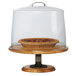 A pie on a Cal-Mil Madera wood pedestal stand with a glass cover.