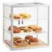 A white Cal-Mil bakery display case with sandwiches and bread inside.