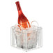 A Cal-Mil Portland white metal ice housing basket with a bottle in ice.