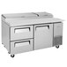 A stainless steel Turbo Air pizza prep table with 2 drawers on wheels.