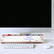 A Quartet floral frameless glass dry erase desktop pad on a black computer screen with a white border with a keyboard and mouse on it.