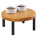 A Cal-Mil Madera rustic pine round wood riser holding two bowls of sauce on a table.