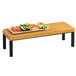 A Cal-Mil Madera wood rectangle riser with a plate of vegetables on it.