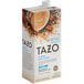 A carton of Tazo Skinny Chai Tea Latte Concentrate on a white background. The carton features a bowl of tea with cinnamon.