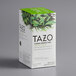 A white box of Tazo China Green Tips Tea Bags with green leaves on it.