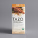 A box of Tazo Organic Chai Tea Bags with a white label and brown spices on a gray background.