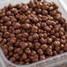 A plastic container of chocolate balls with Buncha Crunch logo.