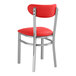 A Lancaster Table & Seating Boomerang red vinyl chair with metal legs.