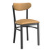 A Lancaster Table & Seating Boomerang Series black chair with light brown vinyl seat and back.