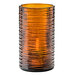 A Hollowick dark amber glass cylinder with a wavy design holding a candle.