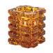 A Hollowick glass amber faceted cube votive candle holder.