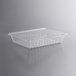 A clear plastic Vigor food drain box with holes.