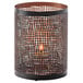A Hollowick Chantilly black metal candle holder with a perforated mesh design holding a lit candle.
