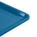 A close-up of a blue Cambro dietary tray with a handle.