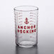 An Anchor Hocking glass measuring cup with red print on a white background.