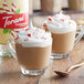 A glass of coffee with Torani Peppermint Flavoring, whipped cream, and candy canes.