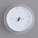 A Taylor round white wall thermometer with a small metal plate inside.